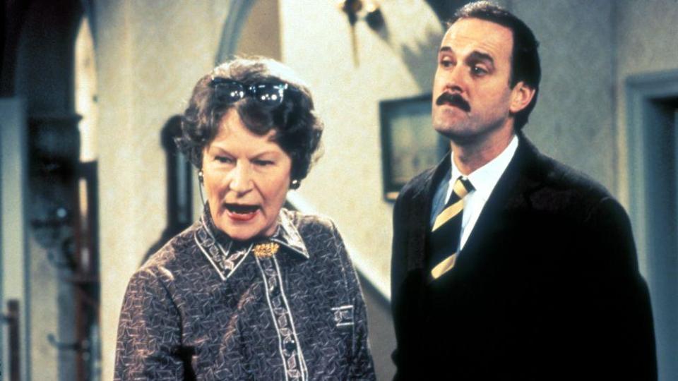 Joan Sanderson and John Cleese as Basil Fawlty, the eccentric hotel owner in the comedy sitcom 'Fawlty Towers'.