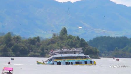 A tourist ferry sinks in the Guatape reservoir in Colombia June 25, 2017 in this still image taken from video obtained from social media. Juan Quiroz/via REUTERS