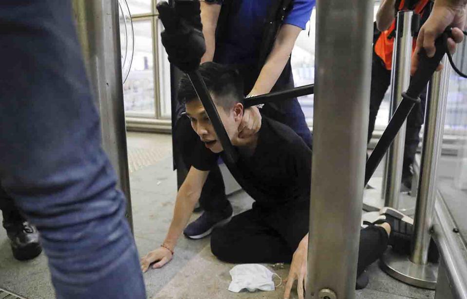 Hong Kong riot police arrest a protester during a demonstration on Tuesday.