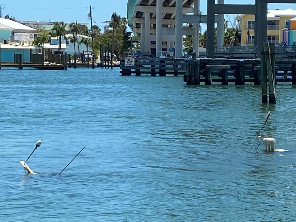 Not far behind where "Batchelor Pad" is stuck are two boat that sunk during Hurricane Ian on Sept. 28, 2022. One is a 38-foot steel tugboat. The other is a sail boat. Their antennas and masts are sticking out of the Mantanzas Pass near Fort Myers Beach.