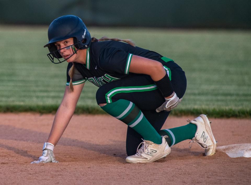 North’s Jinnis Gerth (21) prepares to dash to third as the Huskies play the Castle Knights in the 4A sectional championship at North High School, Saturday night, May 28, 2023.