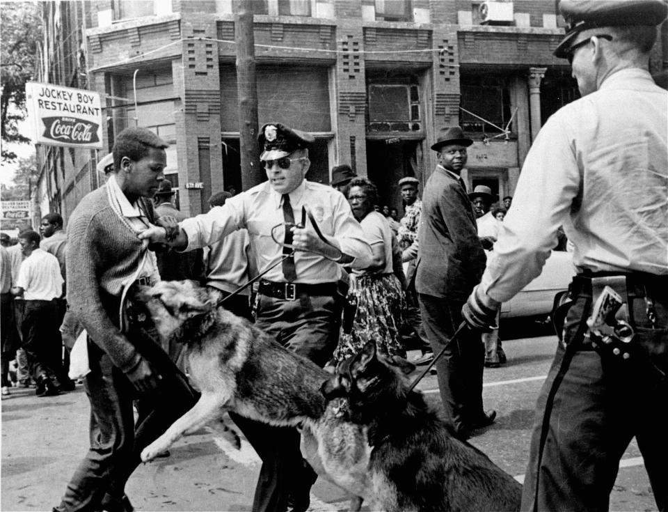 A Black high school student, Walter Gadsden, 15, is attacked by a police dog during a civil rights demonstration in Birmingham, Alabama, in 1963, in this photo by Bill Hudson. These and other iconic images from the Birmingham protests shocked many Americans and helped bring an end to segregation laws.