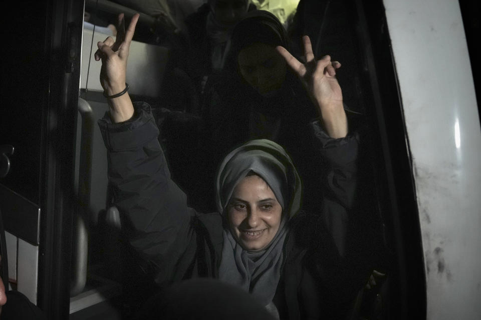 Palestinian Lamis Abu Arkoub is greeted after she was released from prison by Israel, in the West Bank town of Ramallah, early Wednesday Nov. 29, 2023. Hamas and Israel released more hostages and prisoners under terms of a fragile cease-fire that held for a fifth day Tuesday. (AP Photo/Nasser Nasser)