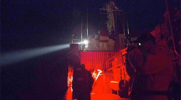 Crew on board Australian Navy ship, the HMAS Success, use a spotlight to search for debris in the southern Indian Ocean. Photo: Reuters.