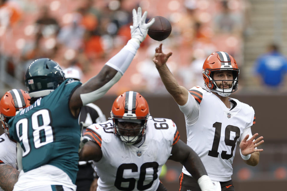 Cleveland Browns quarterback Josh Rosen (19) passes the ball as Philadelphia Eagles defensive tackle Renell Wren (98) applies pressure during the second half of an NFL preseason football game in Cleveland, Sunday, Aug. 21, 2022. (AP Photo/Ron Schwane)