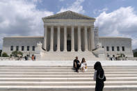 Visitors pose for photographs outside the U.S. Supreme Court Tuesday, June 18, 2024, in Washington. ( AP Photo/Jose Luis Magana)