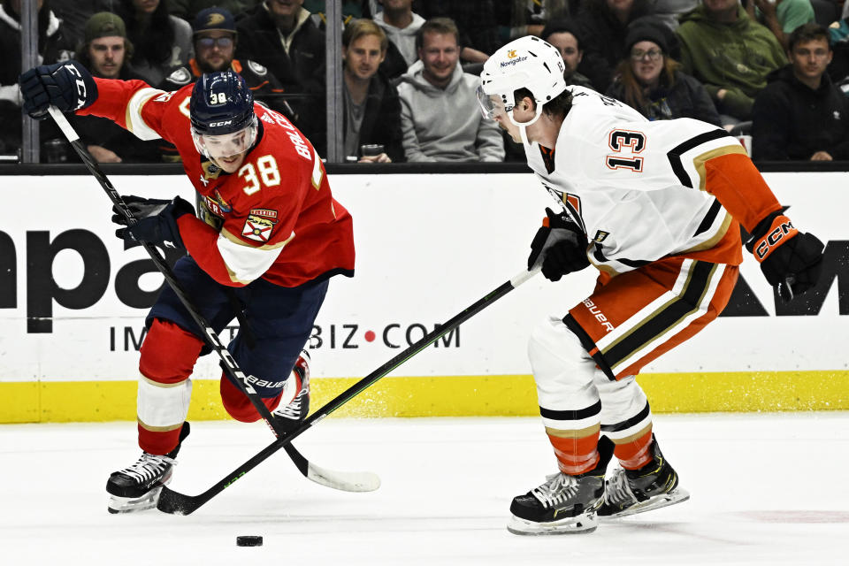 Florida Panthers left wing Rudolfs Balcers, left, controls the puck past Anaheim Ducks defenseman Simon Benoit during the second period of an NHL hockey game in Anaheim, Calif., Sunday, Nov. 6, 2022. (AP Photo/Alex Gallardo)