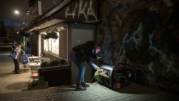 PHOTO: A woman checks on a generator that powers a cafe if there is a power cut in Kyiv, Ukraine, Nov. 5, 2022. (Ed Ram/Getty Images)