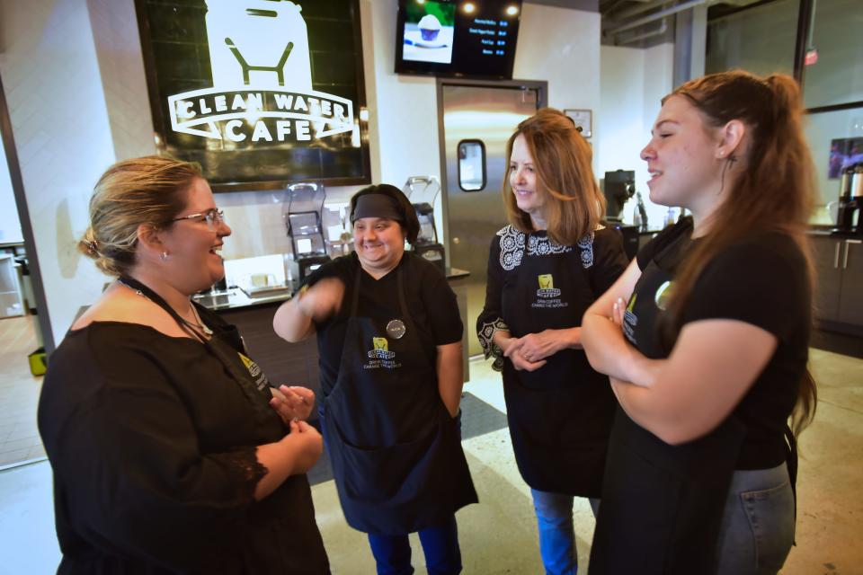 (L to R), Sydney Larino and Alicia Vitiello, chat with staffers  Lois Brooks and Makenna Fabrazzo, at the cashier of ÒClean Water CafŽ" public coffee house that is staffed by special-needs adults at their big converted warehouse facility in Liquid Church located in Parsippany, Wednesday on 09/08/22. 