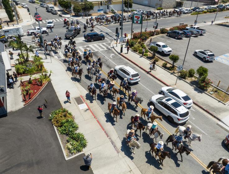 SOUTH EL MONTE, CA - JUNE 24: San Gabriel Valley horse property owners turn onto Michael Hunt Drive in South El Monte enroute to City Hall for a land use planning protest on Saturday, June 24, 2023. They are protesting land modifications that might open their communities to warehouse development and lead to potential environmental ramifications and housing displacement. Photographed at Blackwill Staging Arena Whittier, CA . (Myung J. Chun / Los Angeles Times)