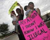 <p>Kathia Ramirez, right, holds her son Rowen Salinas, 11 months, as her husband, Randy Salinas, holds their daughter Fridah Salinas, 2, during a protest in favor of Deferred Action for Childhood Arrivals (DACA), Tuesday, Sept. 5, 2017, in front of the Texas Attorney General’s office in Pharr, Texas. Ramirez, 24, was brought to the U.S. when she was 7-years old, her husband and children are all U.S. citizens. (Photo: Nathan Lambrecht/The Monitor via AP) </p>