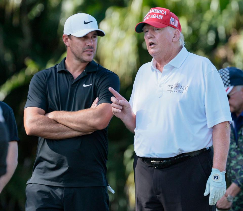 Former President Donald Trump speaks with pro golfer Brooks Koepka  during the LIV Golf Miami Team Championship Pro-Am Tournament at Trump National Doral Golf Club in Doral on Thursday, October 27, 2022. 