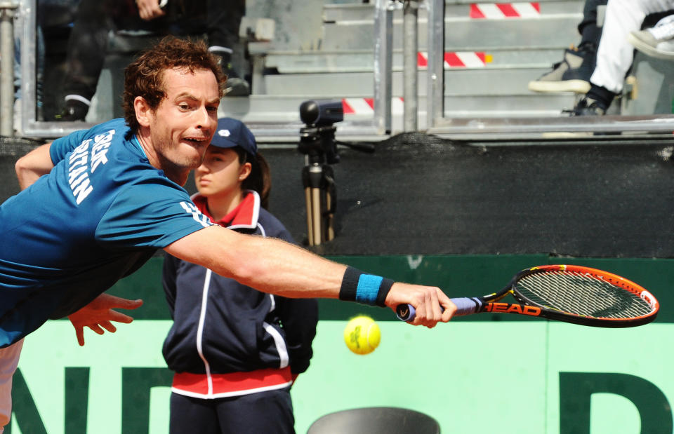 Britain's Andy Murray reaches for a backhand to Italy's Fabio Fognini during a Davis Cup World Group quarterfinal match in Naples, Italy, Sunday, April 6, 2014. (AP Photo/Salvatore Laporta)