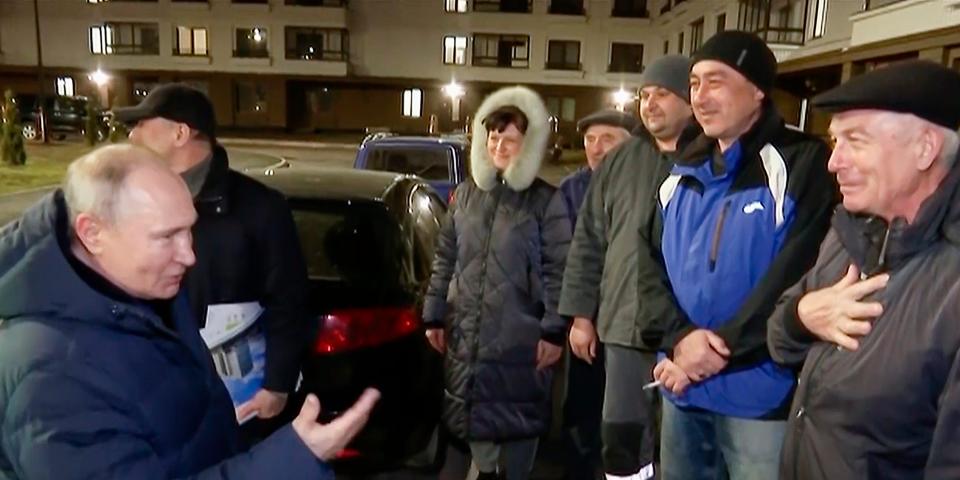 In this photo taken from video released by Russian TV Pool on Sunday, March 19, 2023, Russian President Vladimir Putin talks with local residents during his visit to Mariupol in Russian-controlled Donetsk region, Ukraine.