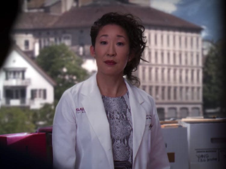 Sandra Oh as Cristina Yang on Greys Anatomy in Switzerland office wearing a dress and white coat