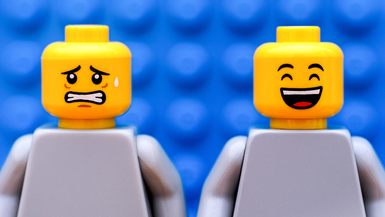 Two Lego minifigures - one scared and one happy.