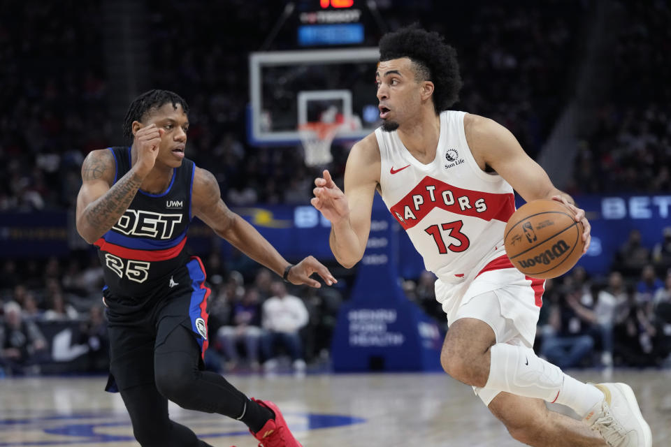 Toronto Raptors forward Jordan Nwora (13) drives as Detroit Pistons guard Marcus Sasser (25) defends during the first half of an NBA basketball game, Wednesday, March 13, 2024, in Detroit. (AP Photo/Carlos Osorio)