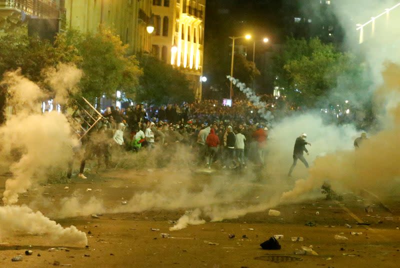 Smoke rises from tear gas during anti government protests in Beirut