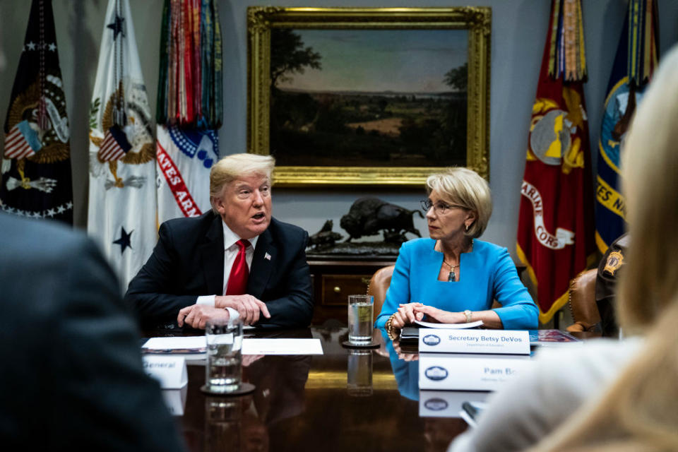 Then-President Donald Trump and then-Education Secretary Betsy DeVos participate in a roundtable to outline the final recommendations by the Federal Commission on School Safety in 2018 at the White House. (Jabin Botsford/The Washington Post/Getty Images)