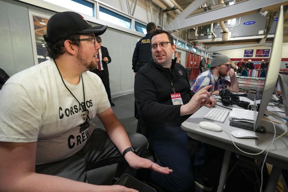 Rick Dunkle (right) talks to student Landon Koons as they prepare for the next game during a day-long broadcast of NCAA Division II midwest regional basketball Saturday, March 11, 2023, at Nicoson Hall at the University of Indianapolis. Dunkle is from Franklin, Indiana, but worked as a writer and producer in Los Angeles for the past two decades. He returned to Indiana to lead the school's student broadcast network, UINDY TV, and serve as assistant professor of practice for the department of communication. 