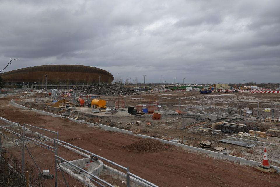 In this Sunday, Feb. 23, 2014 photo, a view of the construction site in Queen Elizabeth Olympic Park in east London. The Games' Velodrome is seen left. London continues to bask in the success of the most recent Summer Games, but the Olympic legacy is difficult to determine. The flagship venue, renamed the Queen Elizabeth Olympic Park, is being converted into a massive park as big as London’s famous Hyde Park, complete with wildlife habitats, woods and sports facilities. The first part of the ambitious project will begin to open to the public in April. The 80,000-seat Olympic Stadium at the center of the park has been troubled by controversy since even before the games, and its post-games use was the subject of months of legal wrangling. The stadium is now being converted into a soccer venue and the home of the West Ham soccer club, with an expected price tag of $323 million. Many argue taxpayers should not have to fund a Premier League club, though officials insist that the stadium will continue to host other major sporting events, including the Rugby World Cup in 2015. (AP Photo/Lefteris Pitarakis)