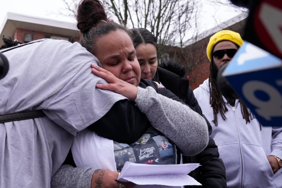 Megan Reed, center, receives a hug while speaking during a community press event about her 13-year-old son Sinzae Reed who was shot and killed on Oct. 12, 2022.