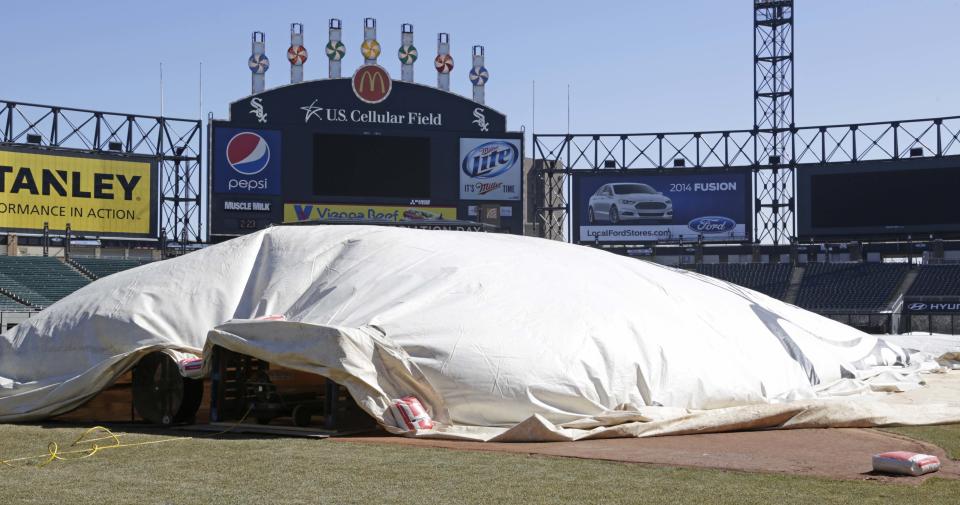 This Monday, March 17, 2014 photo taken in Chicago, shows a tarp covering part of U.S. Cellular Field, home to the Chicago White Sox baseball team, as workers continue to ready the field for opening day, after one of the most brutal winters the city has ever seen. (AP Photo/M. Spencer Green)