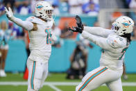 Miami Dolphins outside linebacker Jaelan Phillips (15) congratulates nose tackle Adam Butler (70) after sacking New York Giants quarterback Mike Glennon during the second half of an NFL football game, Sunday, Dec. 5, 2021, in Miami Gardens, Fla. (AP Photo/Wilfredo Lee)