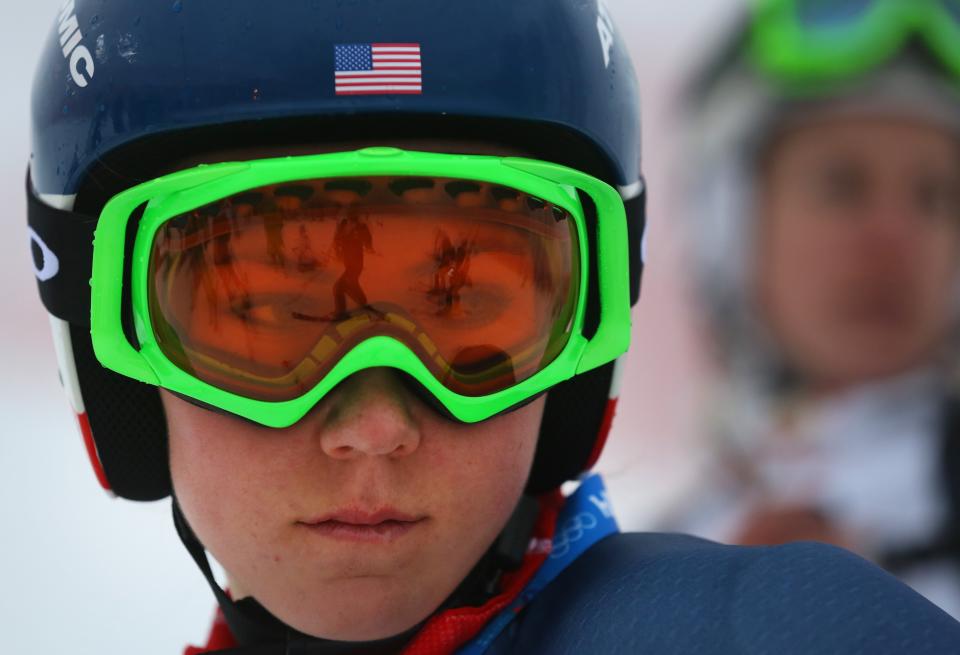 A skier is reflected in the goggles of United States' Mikaela Shiffrin as she stands on the alpine skiing training slopes at the Sochi 2014 Winter Olympics, Monday, Feb. 17, 2014, in Krasnaya Polyana, Russia. (AP Photo/Alessandro Trovati)