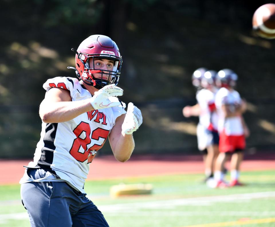 WPI's Douglas Cain hauls in a pass during a recent practice.