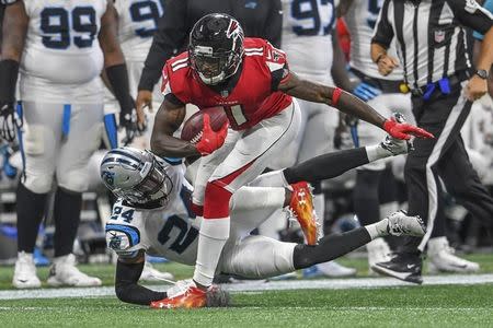 Sep 16, 2018; Atlanta, GA, USA; Atlanta Falcons wide receiver Julio Jones (11) tries to break a tackle by Carolina Panthers cornerback James Bradberry (24) during the second half at Mercedes-Benz Stadium. Mandatory Credit: Dale Zanine-USA TODAY Sports