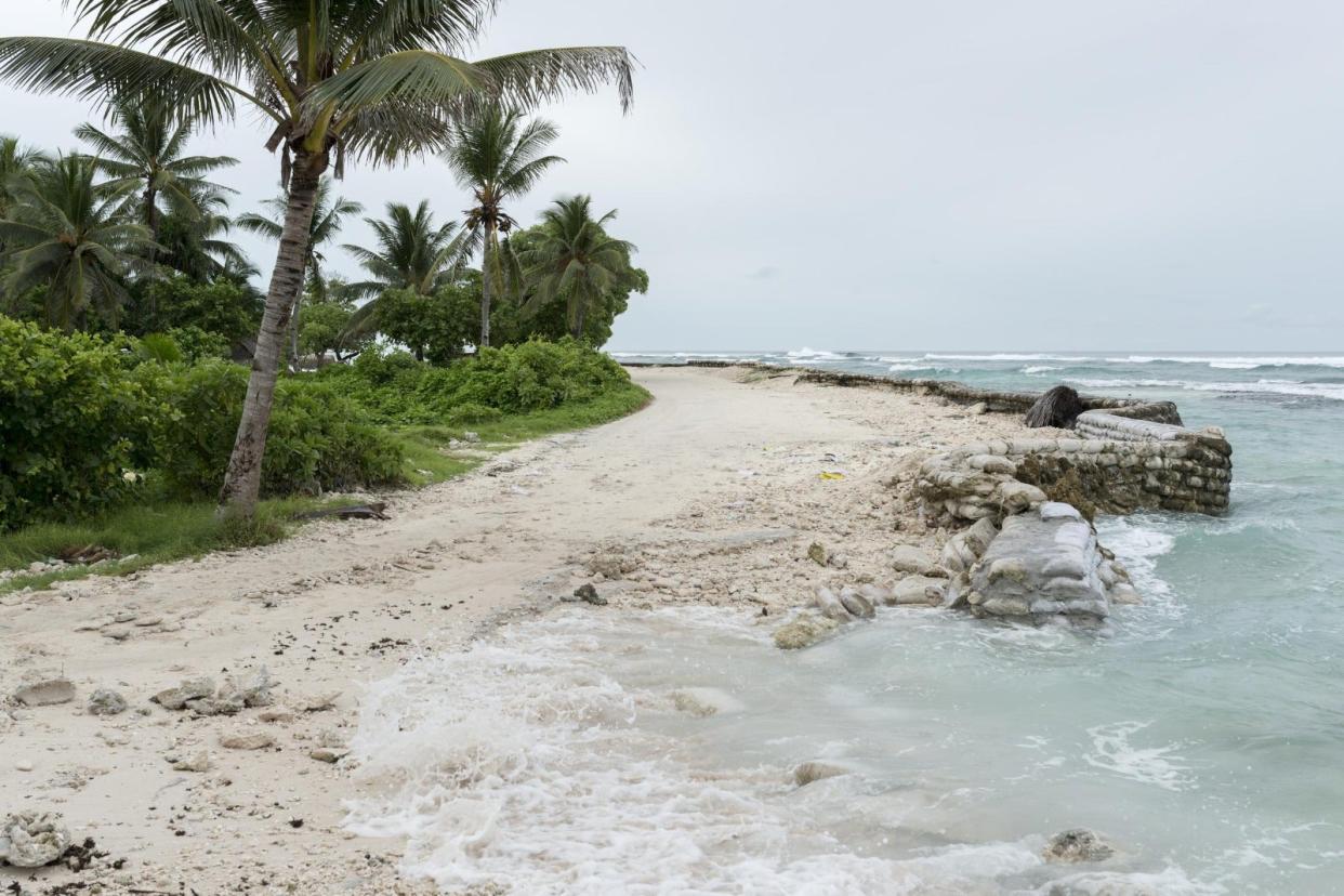 A broken sea wall on Tarawa Island, where the rising ocean is slowly encroaching on their community. (Christian Åslund/ Greenpeace)