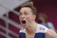 Karsten Warholm, of Norway, celebrates after winning the gold medal in the men's 400-meter hurdles at the 2020 Summer Olympics, Tuesday, Aug. 3, 2021, in Tokyo.(AP Photo/David J. Phillip)