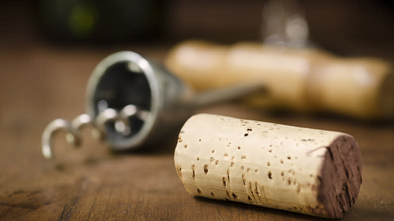 Wine cork with corkscrew in the background 