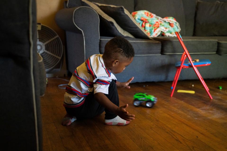 Josiah Sims, 2, plays with toys in the living room at the home his mother inherited from her grandparents in Detroit on Sept. 27, 2022.