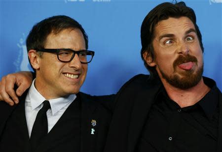 Actor Christian Bale (R) and director David O. Russell pose to promote the movie American Hustle at the 64th Berlinale International Film Festival in Berlin February 7, 2014. The festival runs from February 6 until 16 in the German capital. REUTERS/Tobias Schwarz