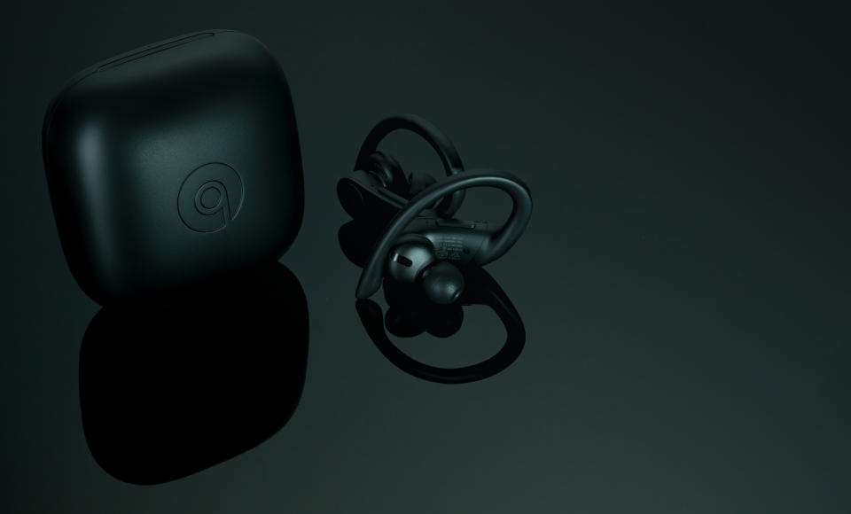 CHONBURI, THAILAND-DECEMBER 26, 2019 : Powerbeats Pro - Totally Wireless Earphones - Black and charging case. Workout earphones on dark background. Apple product. In ear wireless earphones. Earbuds.