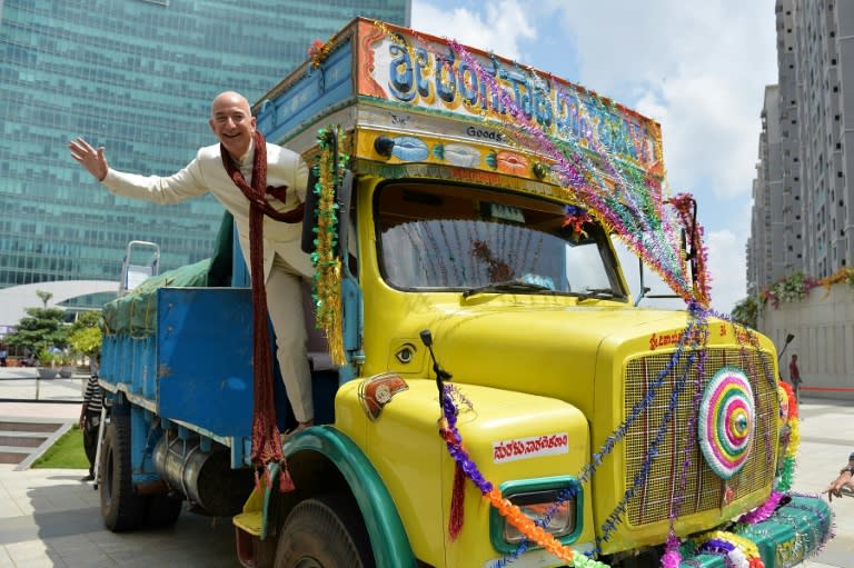 Amazon founder Jeff Bezos poses after handing over a $2 billion cheque to the Indian arm of the US online giant in Bangalore on September 28, 2014. The battle for supremacy in India's bulging e-commerce market is rapidly heating up