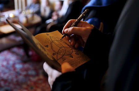 A participant draws on his 'secret book' during a workshop before the role play event at Czocha Castle in Sucha, west southern Poland April 9, 2015.REUTERS/Kacper Pempel