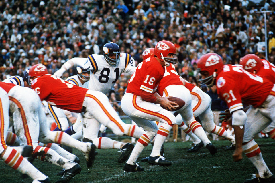 FILE - Kansas City Chiefs quarterback Len Dawson (16) turns around to hand the ball off to running back Mike Garrett (21) during the Super Bowl IV football game in New Orleans., Jan. 11, 1970. Hall of Fame quarterback Len Dawson, who helped the Kansas City Chiefs to a Super Bowl title, died Wednesday, Aug. 24, 2022. He was 87. (AP Photo/File)