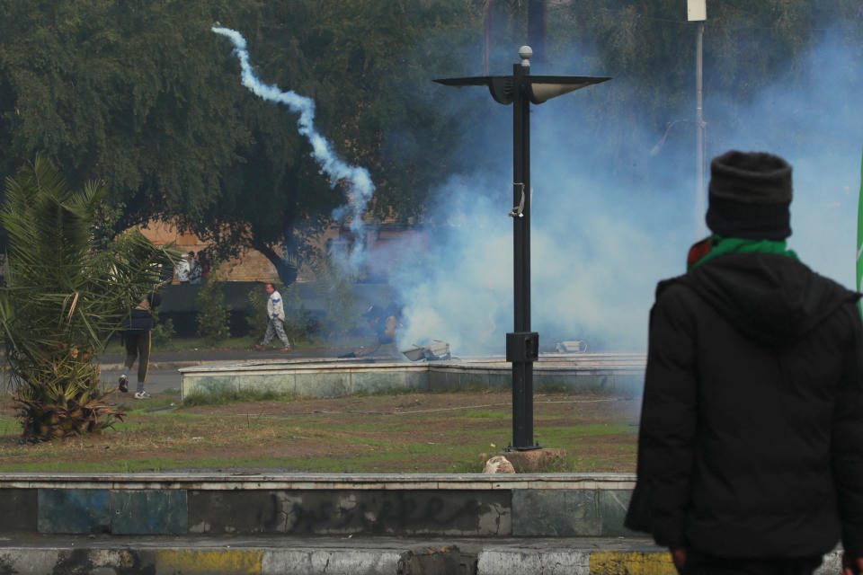 Smoke rise from tear gas fired by security forces during clashes with anti-government protesters in Baghdad, Iraq, Saturday, Jan. 25, 2020. Security forces set fire to anti-government protest tents in the country's south early Saturday and re-opened key public squares in Baghdad that had been occupied by demonstrators for months. (AP Photo/Hadi Mizban)