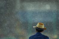 <p>An official is seen as rain falls at the Olympic Stadium on Day 10 of the Rio 2016 Olympic Games on August 15, 2016 in Rio de Janeiro, Brazil. (Getty) </p>