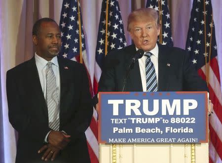 Republican U.S. presidential candidate Donald Trump (R) speaks after receiving the endorsement of former Republican presidential candidate Ben Carson (L) at a campaign event in Palm Beach, Florida March 11, 2016. REUTERS/Carlo Allegri