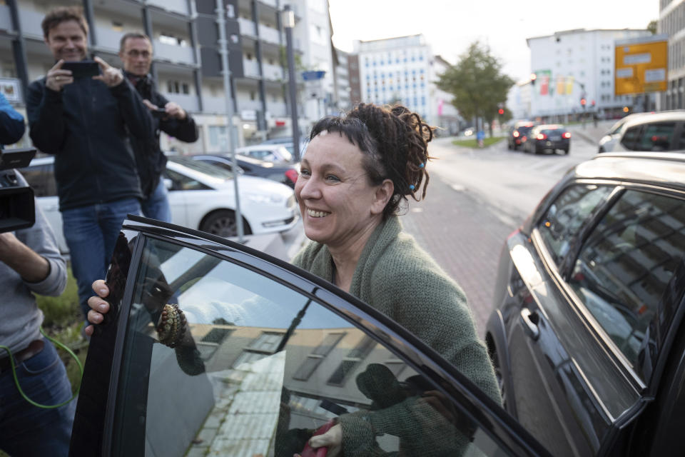 Polish author Olga Tokarczuk smiles as she arrives for a press conference in Bielefeld, Germany, Thursday, Oct 10, 2019. Tokarczuk has been named recipient of the 2018 Nobel Prize in Literature, Thursday. Two Nobel Prizes in literature were announced Thursday after the 2018 literature award was postponed following sex abuse allegations that rocked the Swedish Academy at that time. (Friso Gentsch/dpa via AP)