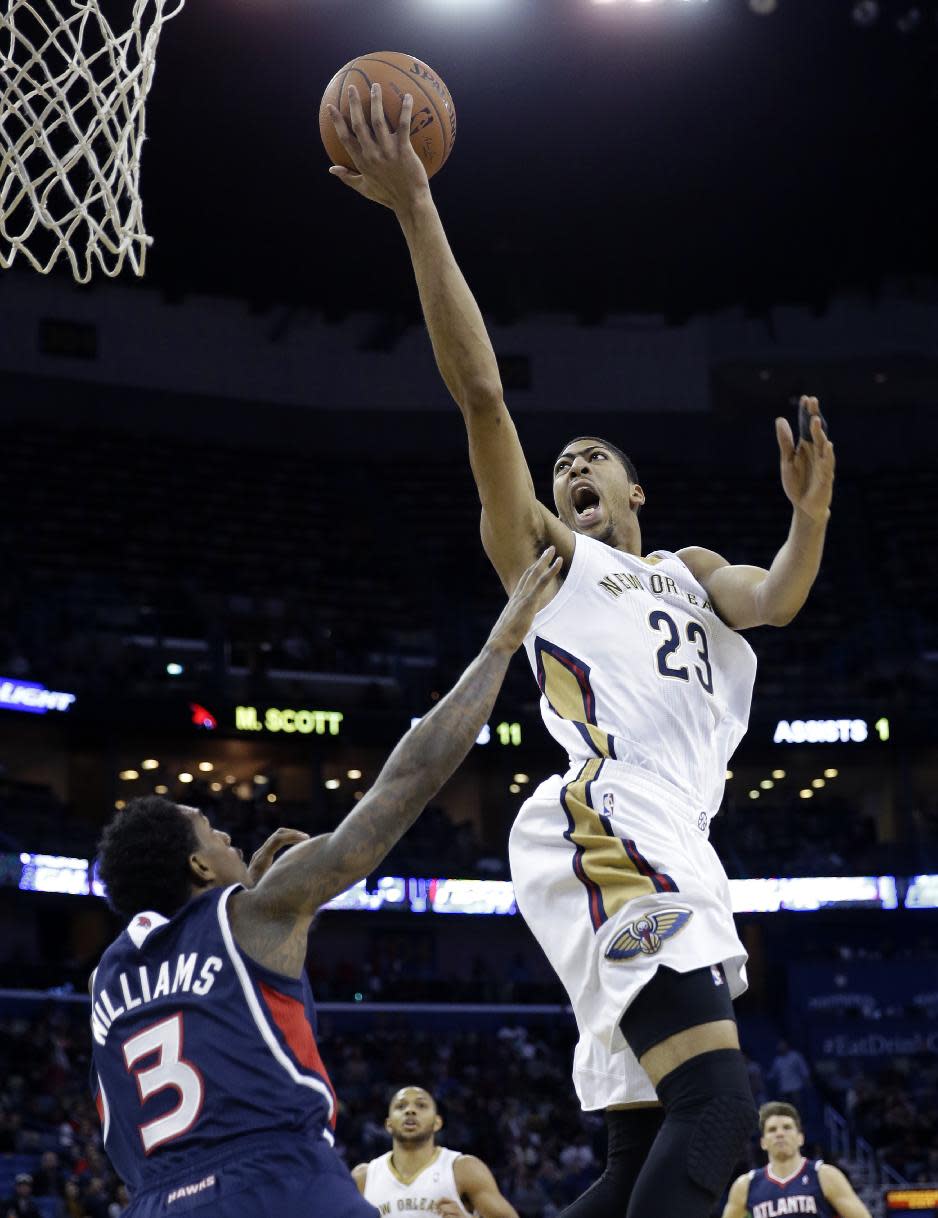 New Orleans Pelicans power forward Anthony Davis (23) goes to the basket over Atlanta Hawks shooting guard Louis Williams (3) in the second half of an NBA basketball game in New Orleans, Wednesday, Feb. 5, 2014. The Pelicans won 105-100. (AP Photo/Gerald Herbert)