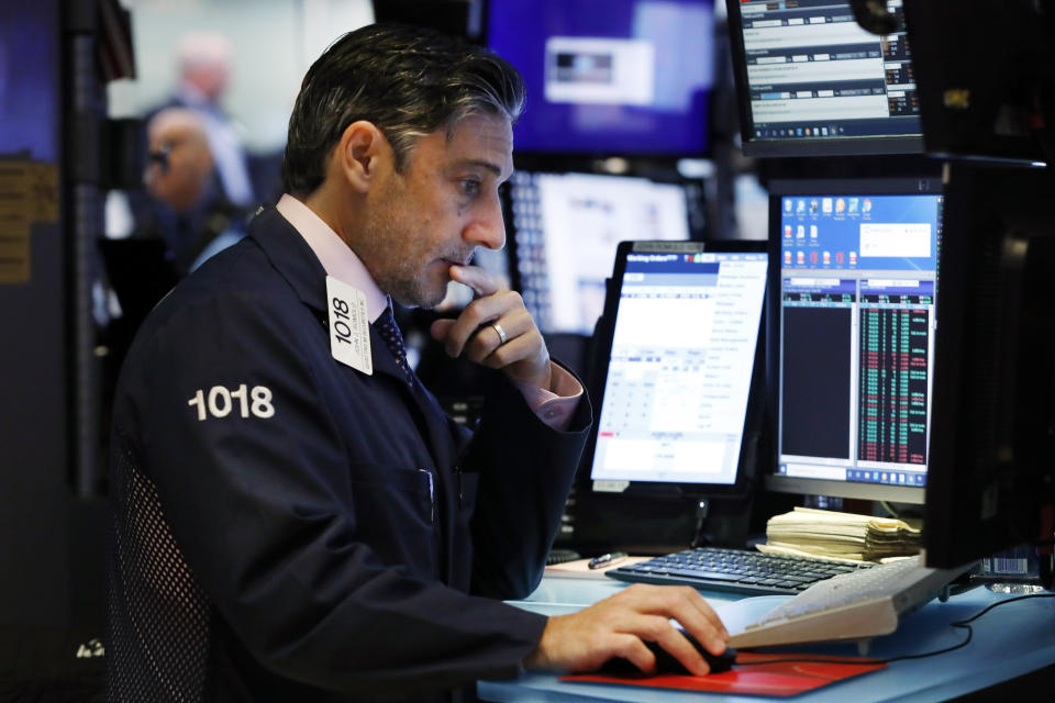 Trader John Romolo works on the floor of the New York Stock Exchange, Tuesday, Oct. 8, 2019. Stocks are opening lower on Wall Street as tensions rose between Washington and Beijing just ahead of the latest round of trade talks. (AP Photo/Richard Drew)