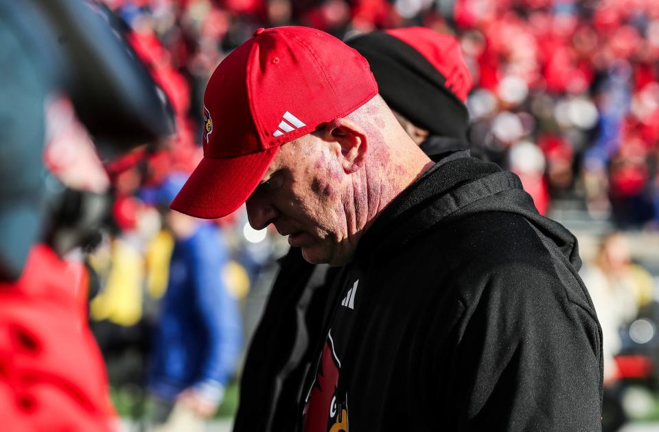 Louisville coach Jeff Brohm walks off the field after Kentucky defeated his team, 38-31, on Saturday. “This one hurts more than the others,” Brohm said. “We wanted to win this game. We put a lot of emphasis on it.”