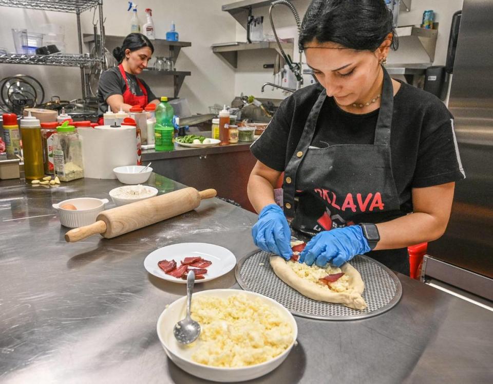 Susanna Karapatyn prepares an order of Georgian cheese bread at at Baklava House now open on Bullard Avenue near West Avenue in Fresno.