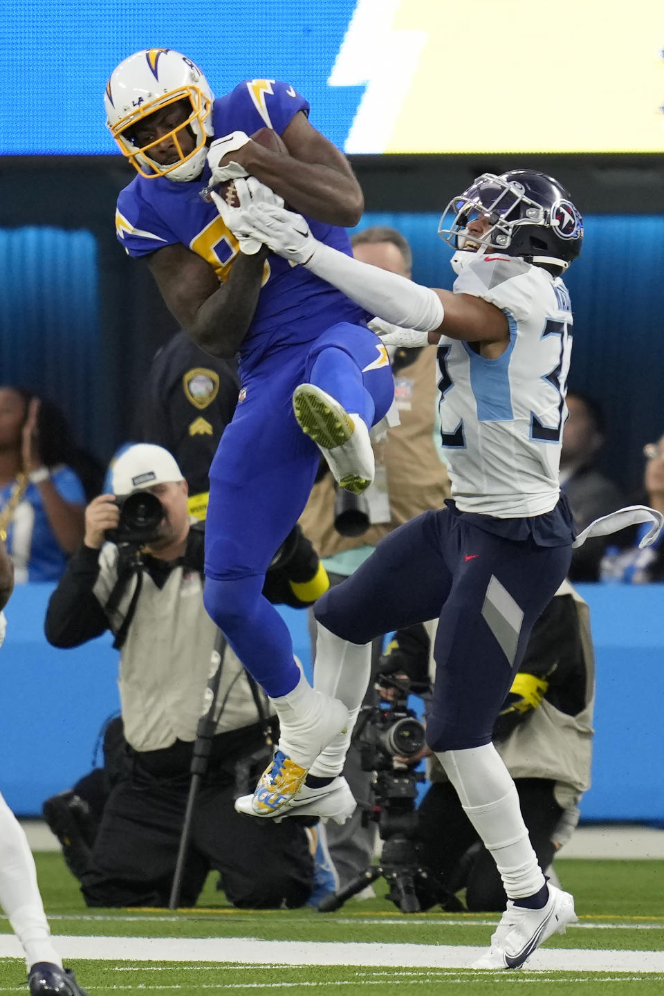 Los Angeles Chargers wide receiver Mike Williams (81) catches a pass in front of Tennessee Titans cornerback Greg Mabin during the second half of an NFL football game in Inglewood, Calif., Sunday, Dec. 18, 2022. (AP Photo/Ashley Landis)