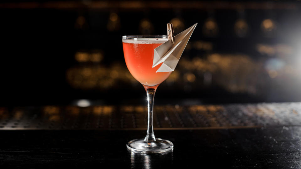 Decorated glass filled with fresh Paper Plane cocktail